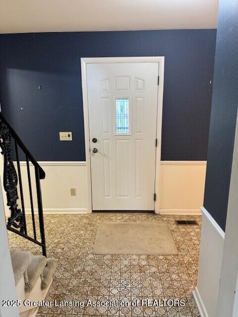 6211 Cobblers Dr, East Lansing, MI 48823 - foyer entrance featuring stairway and light tile patterned floors
