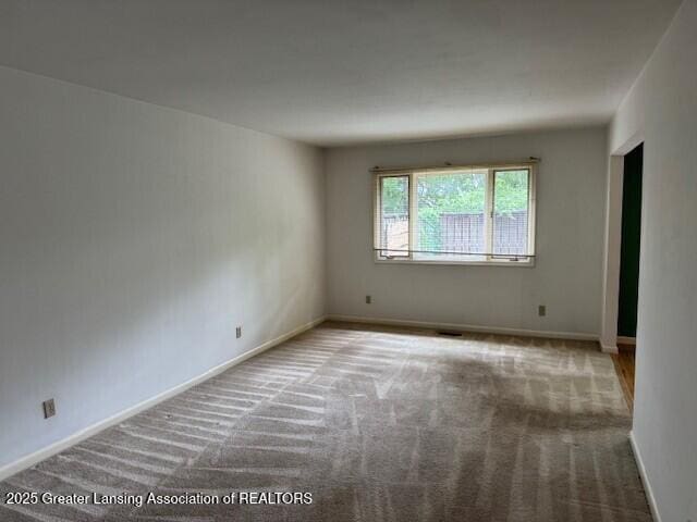 6211 Cobblers Dr, East Lansing, MI 48823 - empty room featuring carpet flooring and baseboards