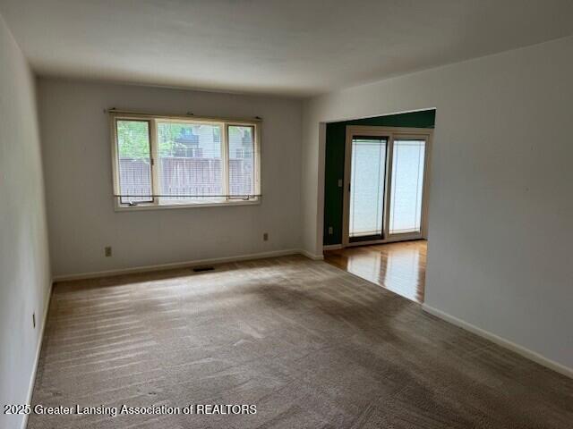 6211 Cobblers Dr, East Lansing, MI 48823 - spare room with carpet floors and baseboards