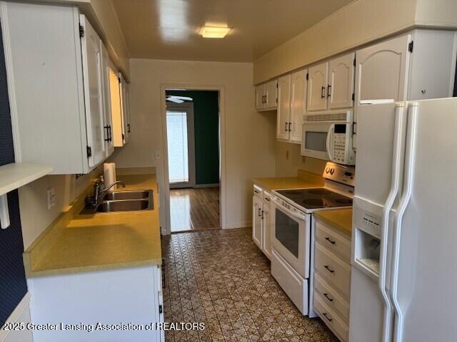 6211 Cobblers Dr, East Lansing, MI 48823 - kitchen with white appliances, white cabinetry, and light countertops
