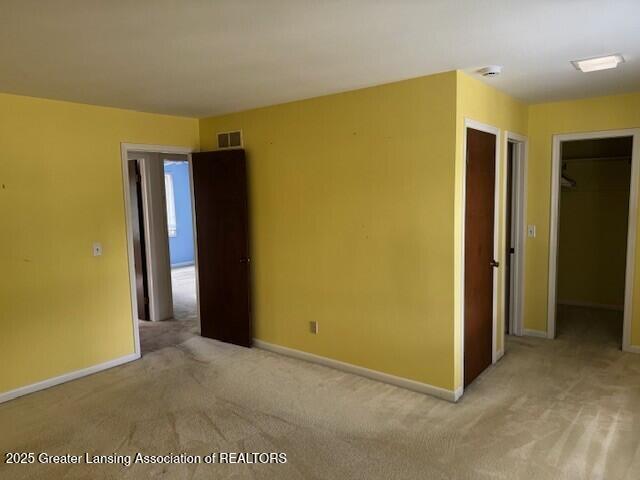 6211 Cobblers Dr, East Lansing, MI 48823 - unfurnished room featuring carpet and a smoke detector