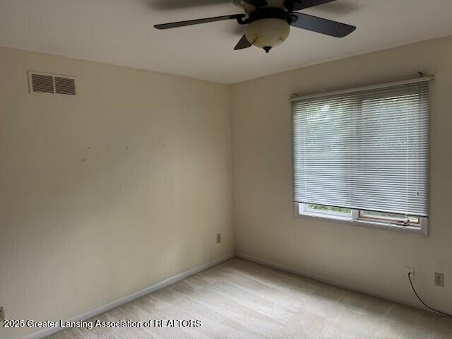 6211 Cobblers Dr, East Lansing, MI 48823 - unfurnished room with plenty of natural light, ceiling fan, and light carpet