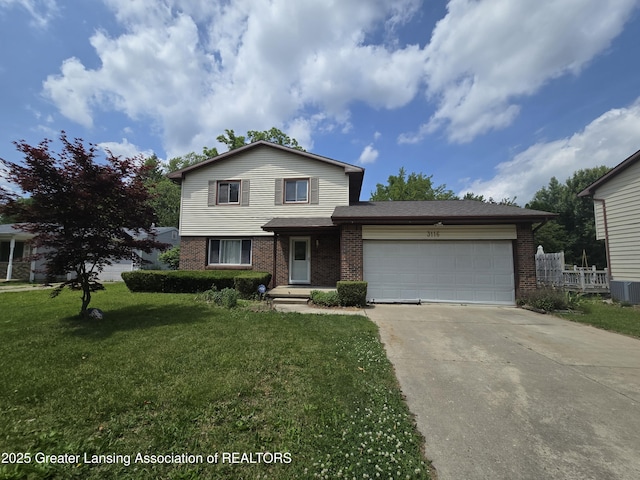 3116 Colchester Rd, Lansing, MI 48906 - view of front of property featuring brick siding, a garage, concrete driveway, and a front yard