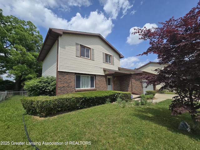 3116 Colchester Rd, Lansing, MI 48906 - traditional-style house with brick siding, an attached garage, and driveway