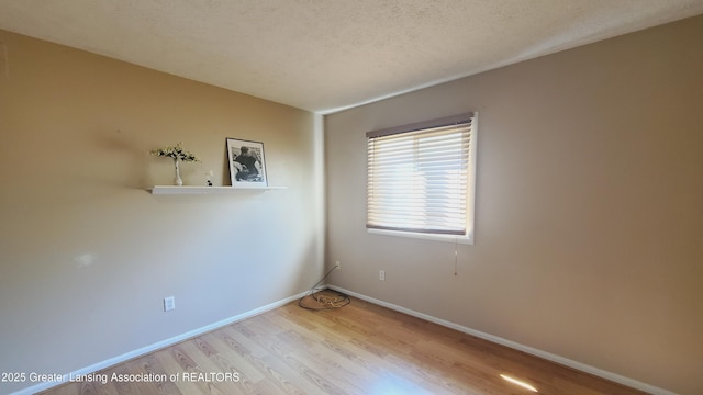 3116 Colchester Rd, Lansing, MI 48906 - spare room featuring wood finished floors and a textured ceiling