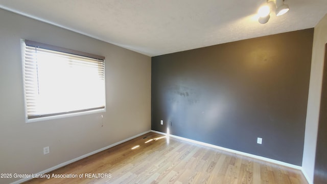 3116 Colchester Rd, Lansing, MI 48906 - empty room with wood finished floors