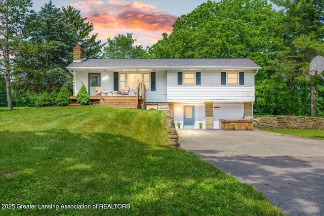 1754 S College Rd, Mason, MI 48854 - view of front of house featuring a chimney, covered porch, stairway, driveway, and a lawn