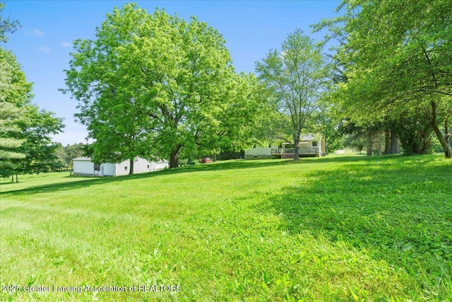 1754 S College Rd, Mason, MI 48854 - view of grassy yard with view of wooded area