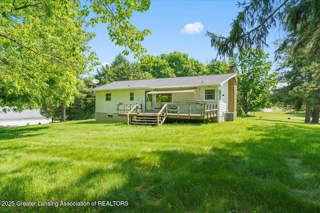1754 S College Rd, Mason, MI 48854 - rear view of house with a chimney, a deck, and a yard