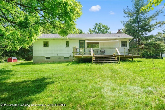 1754 S College Rd, Mason, MI 48854 - rear view of property with a lawn, a storage shed, a wooden deck, and a chimney