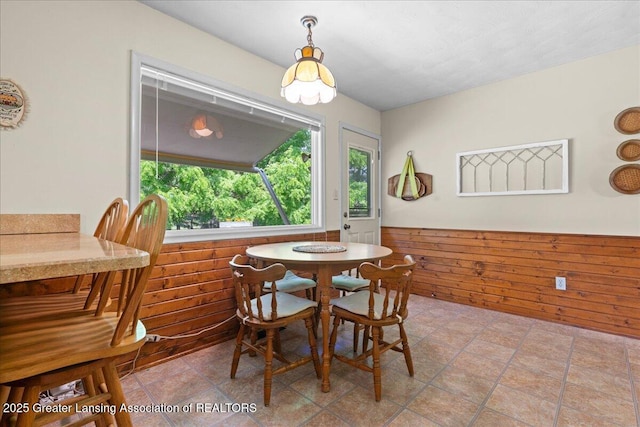 1754 S College Rd, Mason, MI 48854 - dining area featuring a wainscoted wall and wood walls