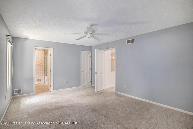 5800 Bent Tree Dr, East Lansing, MI 48823 - unfurnished bedroom with carpet floors, a textured ceiling, ensuite bath, and ceiling fan