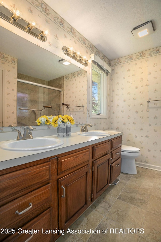 5800 Bent Tree Dr, East Lansing, MI 48823 - bathroom featuring double vanity, wallpapered walls, a stall shower, and a textured ceiling