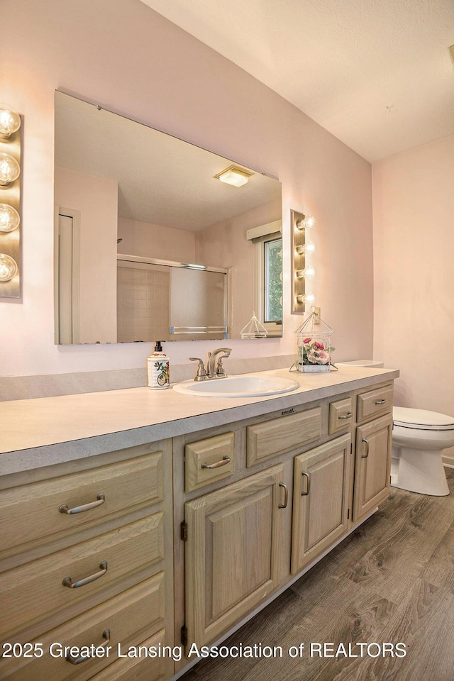 5800 Bent Tree Dr, East Lansing, MI 48823 - full bathroom with vanity, wood finished floors, and a shower with door