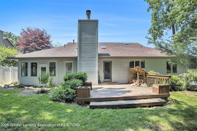 5800 Bent Tree Dr, East Lansing, MI 48823 - back of property featuring a chimney, a wooden deck, and roof with shingles