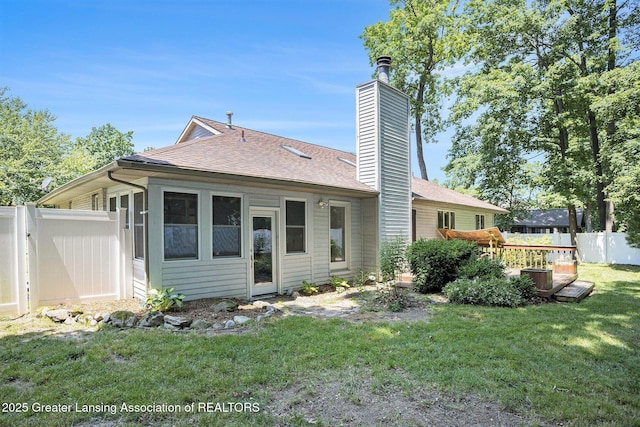 5800 Bent Tree Dr, East Lansing, MI 48823 - back of house with a chimney, roof with shingles, and a wooden deck