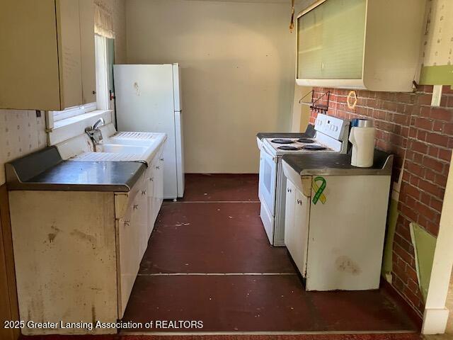 4405 Otto Rd, Charlotte, MI 48813 - kitchen with white appliances and a sink
