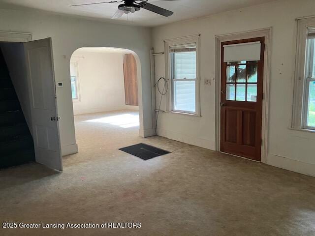 4405 Otto Rd, Charlotte, MI 48813 - entryway featuring arched walkways, carpet floors, a ceiling fan, and healthy amount of natural light
