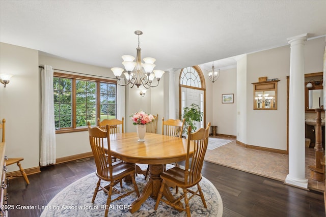 169 Mapleview Dr, Charlotte, MI 48813 - dining room with a chandelier, plenty of natural light, ornate columns, and crown molding