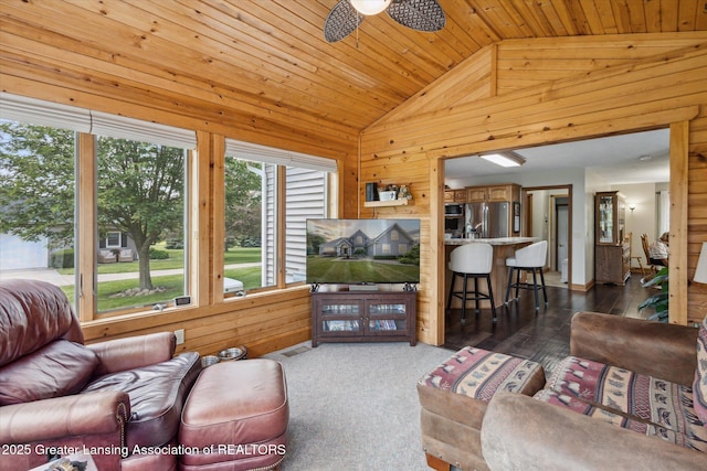 169 Mapleview Dr, Charlotte, MI 48813 - living room featuring wooden walls, vaulted ceiling, a ceiling fan, wood ceiling, and dark wood-type flooring