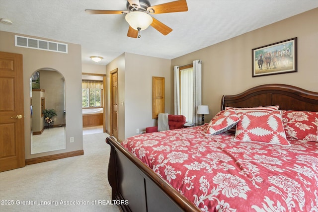169 Mapleview Dr, Charlotte, MI 48813 - bedroom featuring carpet floors, arched walkways, ensuite bathroom, ceiling fan, and a closet