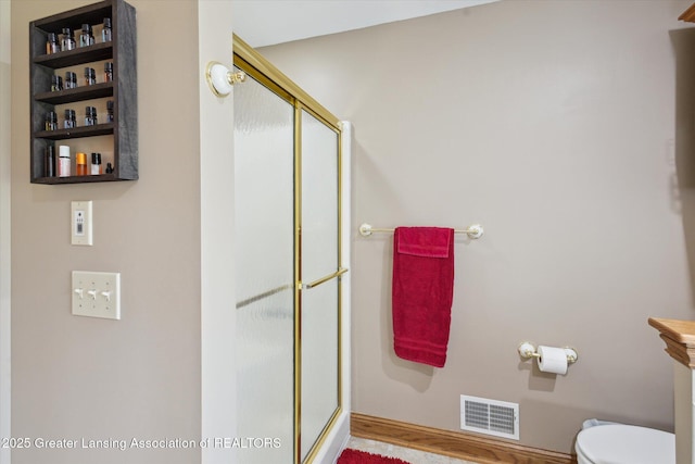 169 Mapleview Dr, Charlotte, MI 48813 - full bath featuring a shower stall and wood finished floors