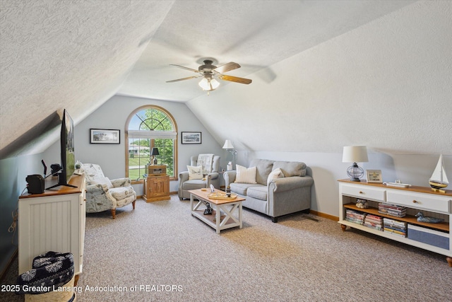 169 Mapleview Dr, Charlotte, MI 48813 - carpeted living room featuring a textured ceiling, a ceiling fan, and vaulted ceiling