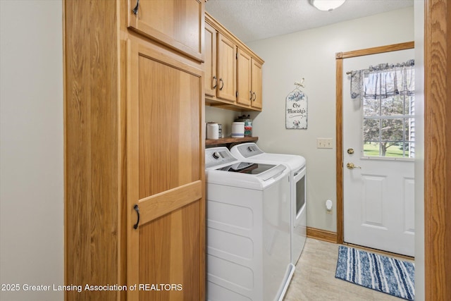 169 Mapleview Dr, Charlotte, MI 48813 - laundry room featuring washer and dryer, cabinet space, a textured ceiling, and light wood-style floors