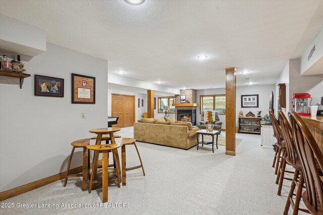 169 Mapleview Dr, Charlotte, MI 48813 - living room featuring a fireplace, light carpet, and recessed lighting
