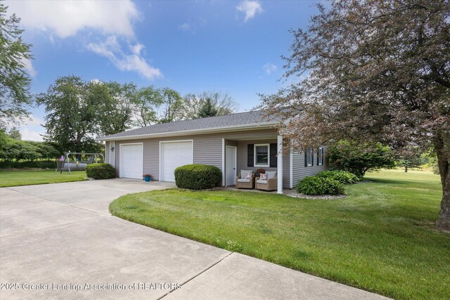 169 Mapleview Dr, Charlotte, MI 48813 - view of front of home with concrete driveway, a front lawn, and a garage