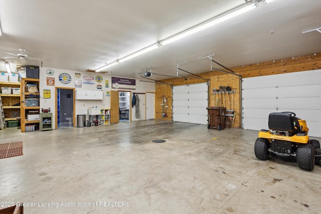 169 Mapleview Dr, Charlotte, MI 48813 - garage featuring a garage door opener and a ceiling fan