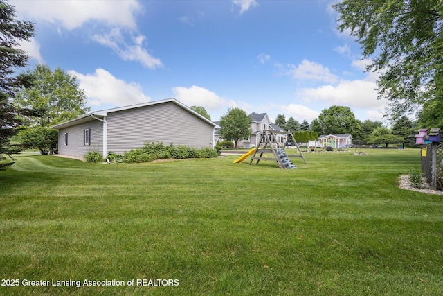 169 Mapleview Dr, Charlotte, MI 48813 - view of grassy yard with a playground