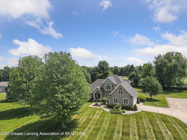 169 Mapleview Dr, Charlotte, MI 48813 - view of front of home featuring a front lawn, driveway, and roof with shingles