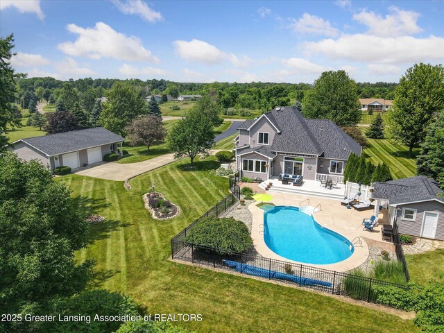 169 Mapleview Dr, Charlotte, MI 48813 - view of swimming pool with a fenced backyard, an outdoor structure, and a patio