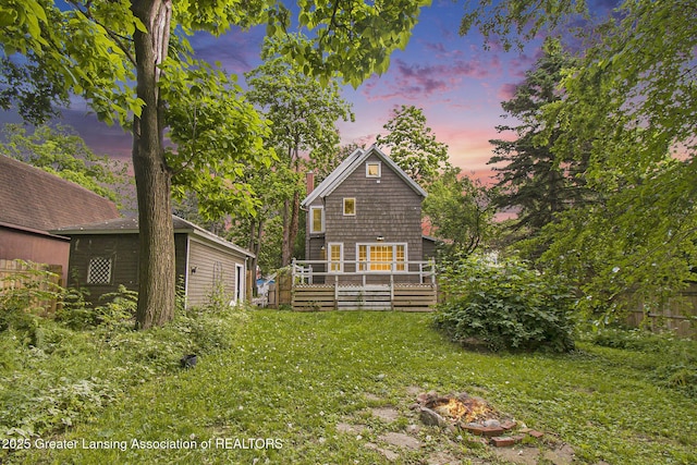 416 E Elm St, Mason, MI 48854 - back of property with a wooden deck and a lawn