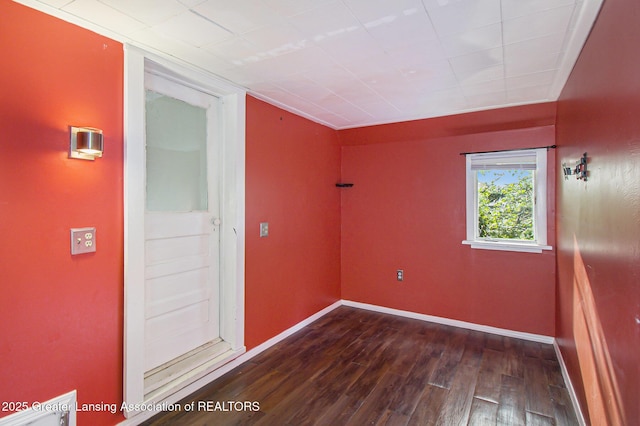 416 E Elm St, Mason, MI 48854 - empty room featuring dark wood-style floors and baseboards