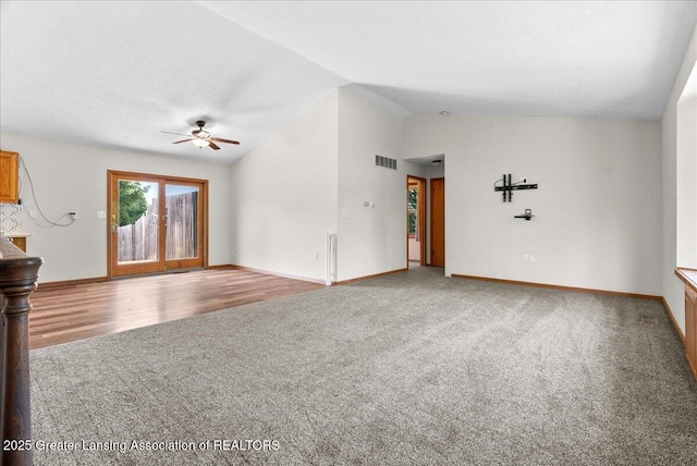 1313 W Alward Rd, Dewitt, MI 48820 - unfurnished living room featuring carpet flooring, vaulted ceiling, and a ceiling fan