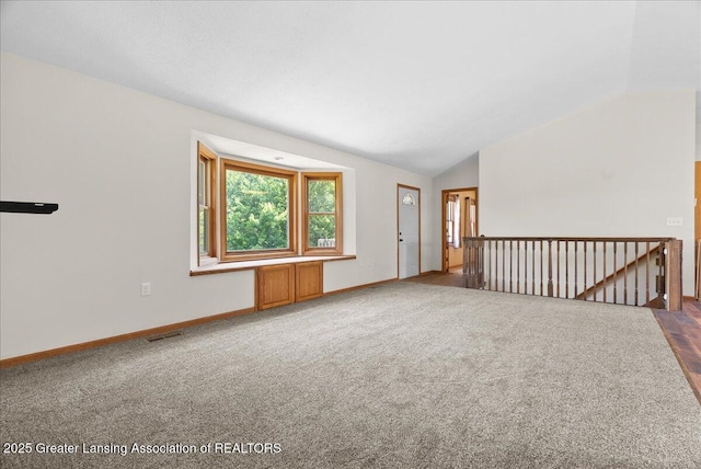 1313 W Alward Rd, Dewitt, MI 48820 - unfurnished room featuring lofted ceiling and carpet flooring
