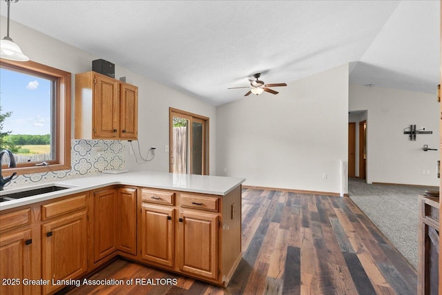 1313 W Alward Rd, Dewitt, MI 48820 - kitchen with lofted ceiling, a ceiling fan, healthy amount of natural light, a peninsula, and light countertops