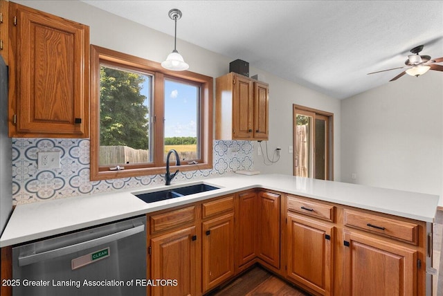 1313 W Alward Rd, Dewitt, MI 48820 - kitchen featuring stainless steel dishwasher, a peninsula, decorative backsplash, light countertops, and ceiling fan