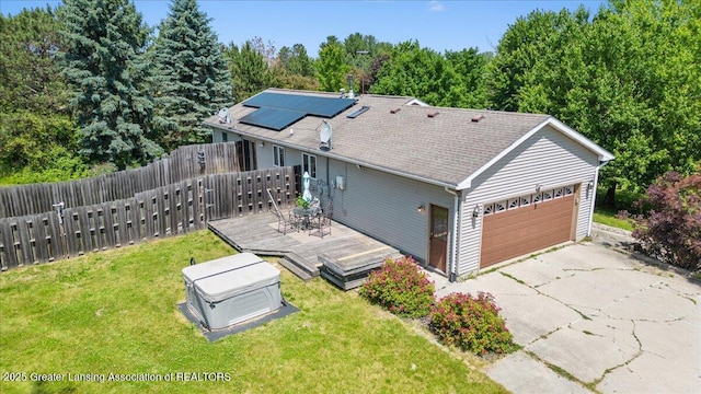 1313 W Alward Rd, Dewitt, MI 48820 - view of property exterior featuring a garage, roof mounted solar panels, a wooden deck, and driveway