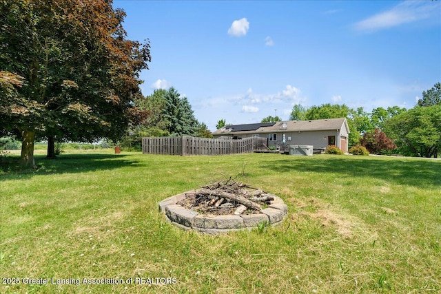 1313 W Alward Rd, Dewitt, MI 48820 - view of grassy yard featuring a fire pit and a deck