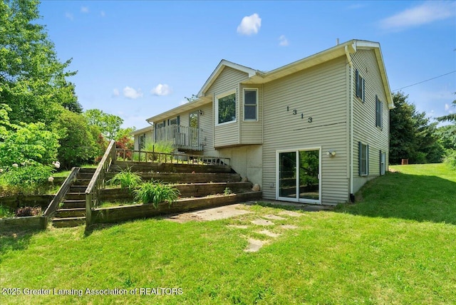 1313 W Alward Rd, Dewitt, MI 48820 - rear view of house with stairway and a lawn