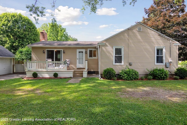6244 Daft St, Lansing, MI 48911 - view of front of home featuring a chimney, a front yard, a deck, an outdoor structure, and a garage