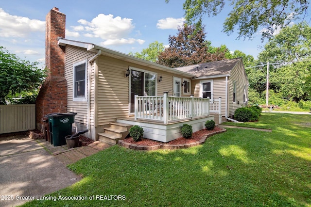 6244 Daft St, Lansing, MI 48911 - rear view of property with a chimney and a deck
