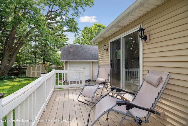 6244 Daft St, Lansing, MI 48911 - deck with a storage shed, a garage, and a lawn