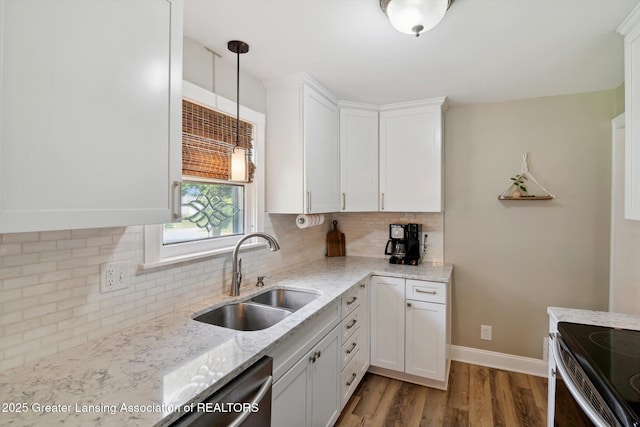 6244 Daft St, Lansing, MI 48911 - kitchen featuring white cabinets, wood finished floors, light stone countertops, decorative backsplash, and pendant lighting