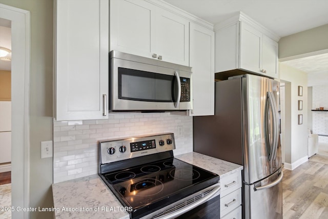 6244 Daft St, Lansing, MI 48911 - kitchen featuring stainless steel appliances, light wood finished floors, light stone countertops, and tasteful backsplash