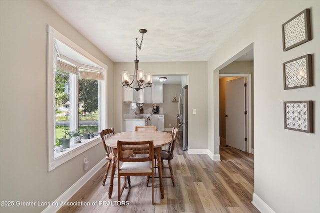 6244 Daft St, Lansing, MI 48911 - dining area with a chandelier and light wood finished floors