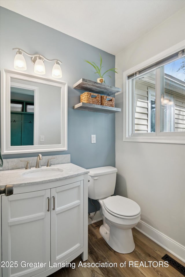 6244 Daft St, Lansing, MI 48911 - half bathroom with wood finished floors and vanity
